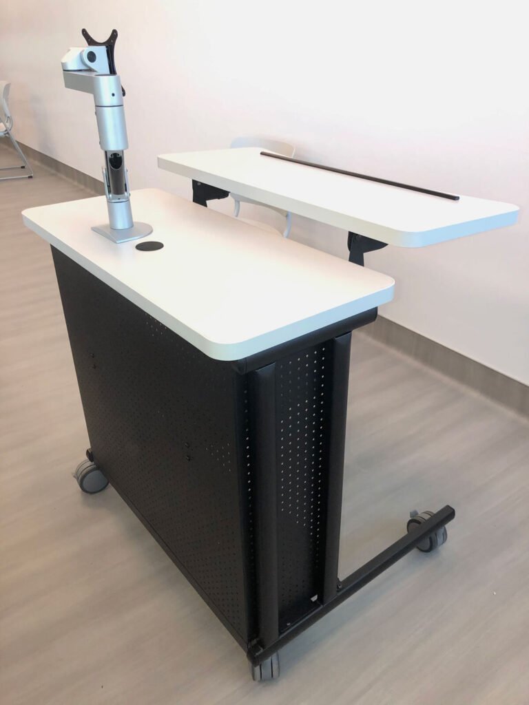 Computer Comforts' Freedom Instructor Cart shown with height adjustable front surface and fully articulating monitor arm