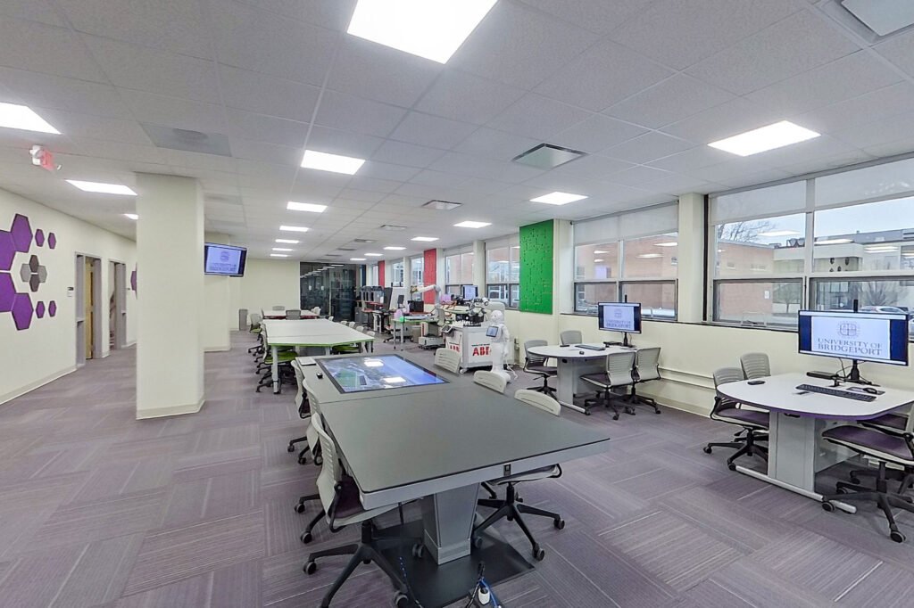 Furniture installation at University of Bridgeport featuring the Coligo Acoustic Panels, Collaborative Table Series, AdapTable Series, Addo Acoustic Panels and OM5 Active Task Chair.